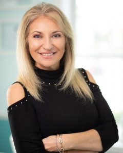 Pam Cavalcante wearing a black top with open shoulders