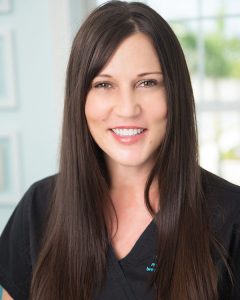 Headshot of Stacy Jayn RN wearing black scrubs with MD logo