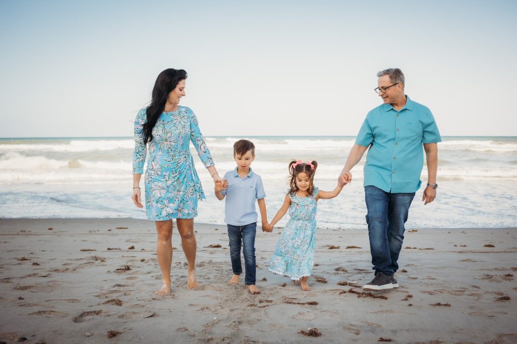 Dr. Diaz and his family walking along the beach in Vero, FL